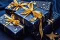 Holiday luxury gift boxes with golden bow ribbons and decor on blue background.Christmas gift wrapping