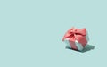 Holiday Luxury stylish gift present box tied with pink bow on blue background. Birthday, Christmas, New Year, Mother day, sale Royalty Free Stock Photo