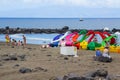 Holiday makers enjoy the welcome relief of an overcast sky as the sunbath on the sandy beach at Playa Las Americas in Teneriffe in Royalty Free Stock Photo