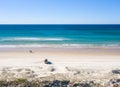 Holiday makers enjoying the beach. Tourists enjoy driving and stopping with their car, 4wd driving on infinite beach. Royalty Free Stock Photo