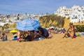 Holiday makers relax in the hot sun on the beach at the Old Town in Albuferia Royalty Free Stock Photo