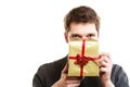 Holiday. Man giving golden gift box with ribbon Royalty Free Stock Photo