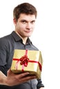 Holiday. Man giving golden gift box with ribbon Royalty Free Stock Photo