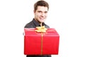 Holiday. Man giving red gift box with golden ribbon Royalty Free Stock Photo