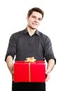 Holiday. Man giving red gift box with golden ribbon Royalty Free Stock Photo