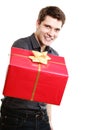 Holiday. Man giving red gift box with golden ribbon Royalty Free Stock Photo