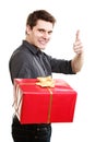 Holiday. Man giving red gift box showing thumb up Royalty Free Stock Photo