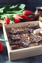 Holiday mood. Dark handmade chocolate with nuts, coffee and red tulips