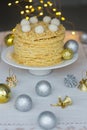 Holiday Napoleon cake or puff pastry cake for Christmas or New Year party with coconut chips `snowballs` on top