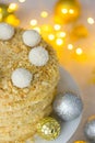 Holiday Napoleon cake or puff pastry cake for Christmas or New Year party with coconut chips `snowballs` on top