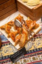 The Holiday Of Navruz. National color.A traditional dish of pakhlava dough.On a brown wooden plate on a silk scarf with a national