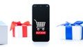 Holiday online shopping. Internet shop application on digital smartphone screen with gift box red ribbon in online Royalty Free Stock Photo