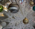 Holiday ornaments hanging in front of window to help welcome in the Winter season