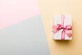 holiday paper present tied pink ribbon bow top view with copy space. Flat lay holiday background. Birthday or christmas Royalty Free Stock Photo