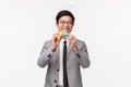 Holiday, people and celebration concept. Waist-up of silly and happy young handsome asian man in suit, rabbit ears, wink Royalty Free Stock Photo