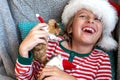 Holiday Pets Christmas guinea pig Cute boy hugs his pets guinea pig Boy in red Santa Hat Royalty Free Stock Photo