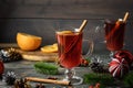 A holiday photo of a glass of mulled wine with orange, anise and cinnamon. Cozy Christmas atmosphere