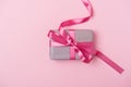 Holiday pink background with gift, rose bow, ribbon. Valentine`s Day, Happy Women`s Day, Mother`s Day, Birthday, Wedding, Chris