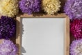 Holiday postcard greeting card empty paper note frame around mixed colorful flowers. Copy space mockup template Royalty Free Stock Photo