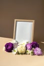 Holiday postcard greeting card photo frame empty paper note around mixed colorful flowers. Copy space mockup template Royalty Free Stock Photo