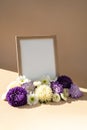 Holiday postcard greeting card photo frame empty paper note around mixed colorful flowers. Copy space mockup template Royalty Free Stock Photo