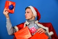 Holiday presents concept. Man looks at red xmas gift box.