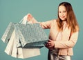 Holiday purchase saving. Sales and discounts. Kid fashion. shop assistant with package. Small girl with shopping bags