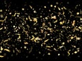 Holiday realistic gold confetti flying on black background.