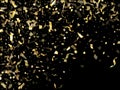 Holiday realistic gold confetti flying on black background. Royalty Free Stock Photo