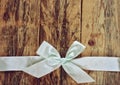 Holiday retro background with white ribbon and bow