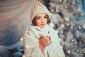 Holiday is ruined! Young beautiful woman in knitted hat and scarf rolled in plaid having flu and blowing her nose at handkerchief Royalty Free Stock Photo