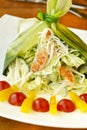 Holiday salad with crab, shrimp and vegetables in leek leaf