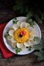 Holiday salad `Flower` with boiled eggs and chips. Christmas background