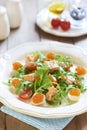 Holiday salad with salmon, quail eggs, cherry tomatoes and red caviar