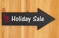 Holiday Sale type message on hanging arrow chalkboard sign with a red present
