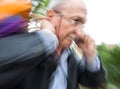 Holiday sales. An elderly man with many shopping bags in his han Royalty Free Stock Photo