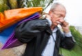 Holiday sales. An elderly man with many shopping bags in his han Royalty Free Stock Photo