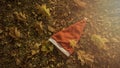 Holiday season is coming soon. A conceptual background photo of Santa Claus hat on yellow leaves in fall. Last day of autumn and