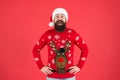 Holiday season mood. bearded man santa hat red background. merry christmas. ready for xmas party. happy new year Royalty Free Stock Photo