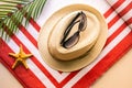 Holiday season, Summer trips to the seaside, panama hat, beach towel, sunglasses, large green leaf of an exotic tree