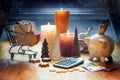 Holiday shopping. Calculator, Christmas decoration, calculator, piggy bank, shopping cart and candles on a table against a blue Royalty Free Stock Photo