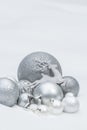 Holiday silver decorative Christmas baubles and star with Santa Claus's reindeer at natural snow background Royalty Free Stock Photo