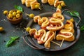 Holiday snack puff dough Christmas tree with olive and bacon on a slate or stone tabletop.