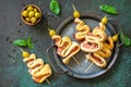 Holiday snack puff dough Christmas tree with olive and bacon on a slate or stone tabletop.