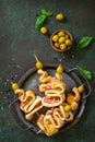 Holiday snack puff dough Christmas tree with olive and bacon on a slate or stone tabletop.