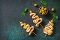 Holiday snack puff dough Christmas tree with olive and bacon on a slate or stone tabletop.