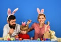 Holiday spirit and joy concept. Family members painting eggs