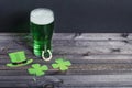 Holiday St. Patrick`s Day. Green beer with clover and horseshoe on a dark wooden background with copy space Royalty Free Stock Photo