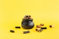 holiday sweets in a witch\'s cauldron and next to it on a yellow background