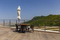 Holiday tables, chairs and closed umbrellas on the porch Royalty Free Stock Photo